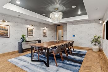 A dining room with a wooden table and chairs.